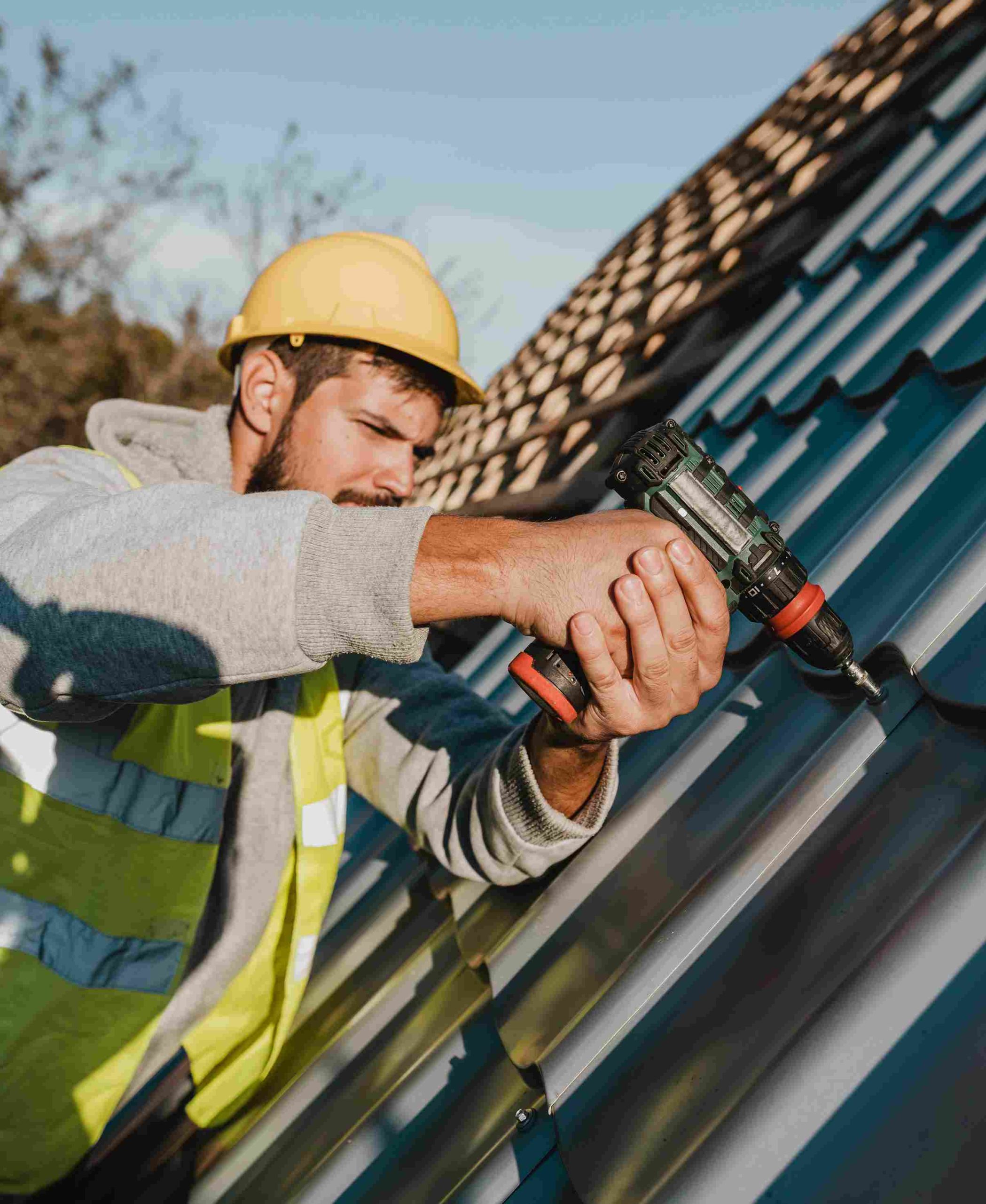 side-view-man-working-roof-with-drill_11zon