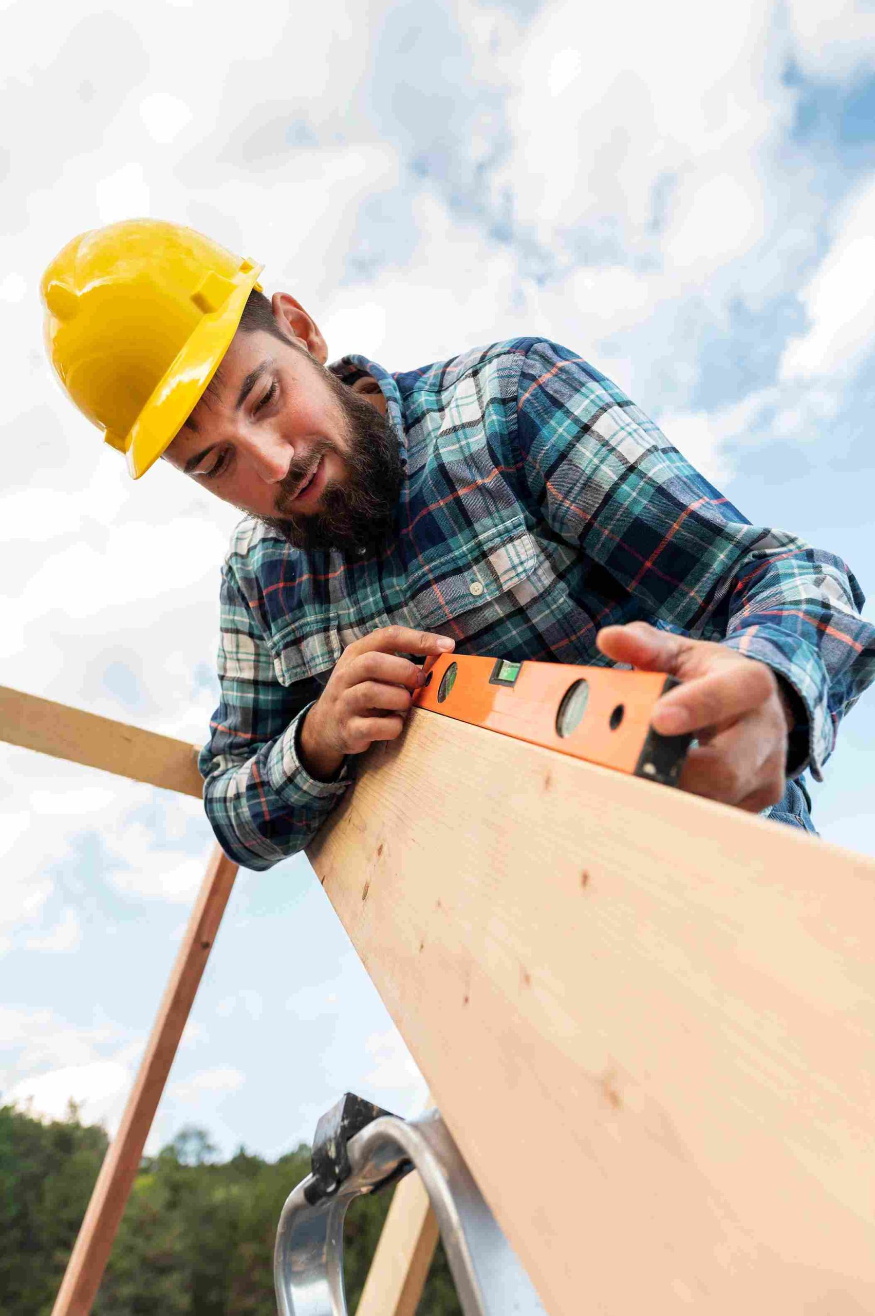 worker-with-hard-hat-level-checking-roof-timber_11zon