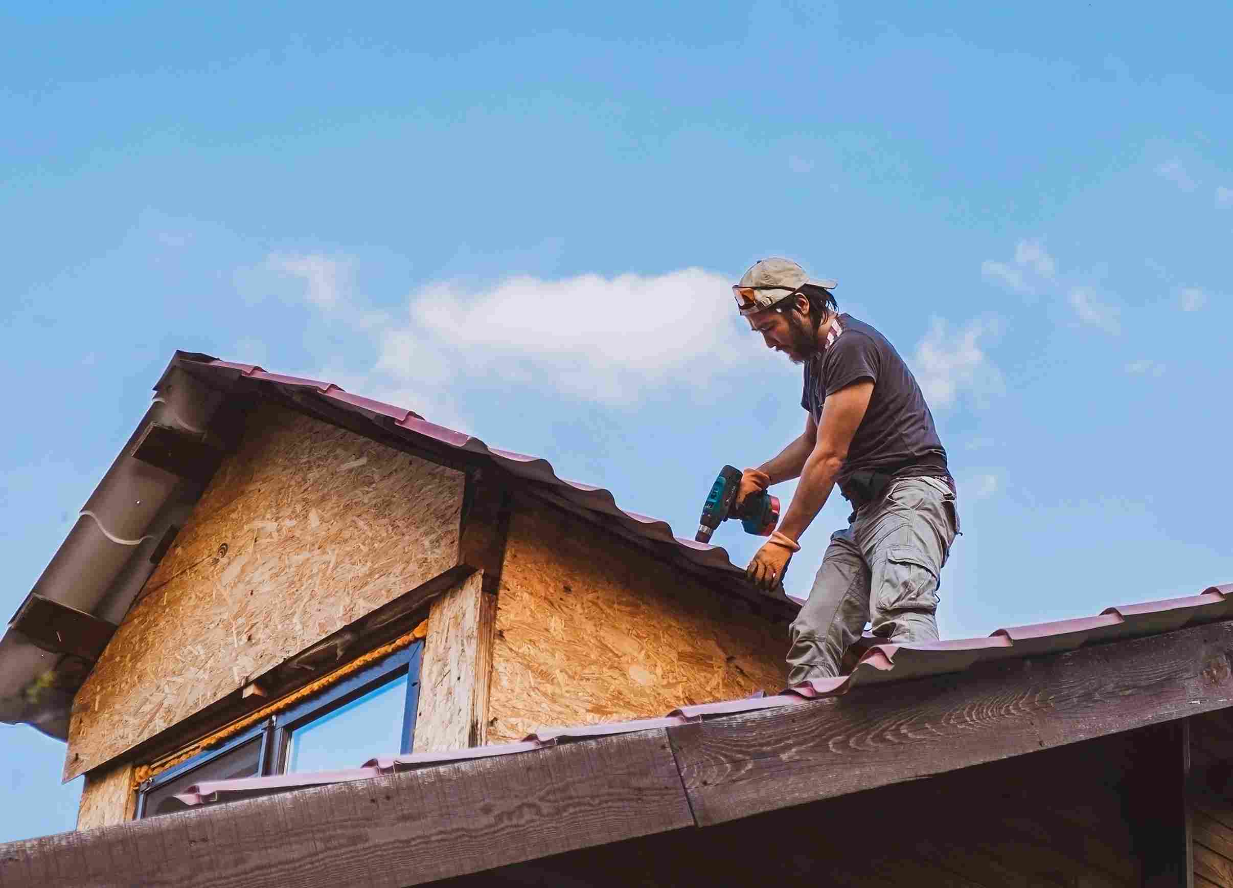 man-working-roof-using-electric-screwdriver_11zon (1)